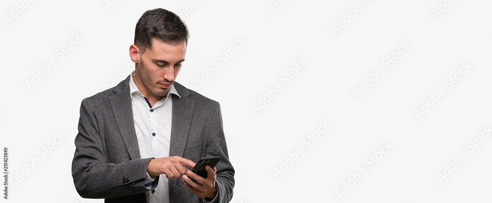 Handsome young man using smartphone with a confident expression on smart face thinking serious Handsome young man using smartphone with a confident expression on smart face thinking serious