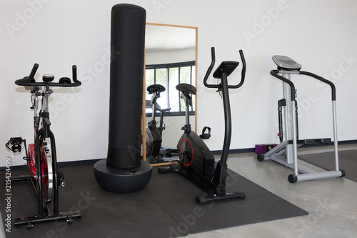 Room with gym equipment sport machines in fitness room