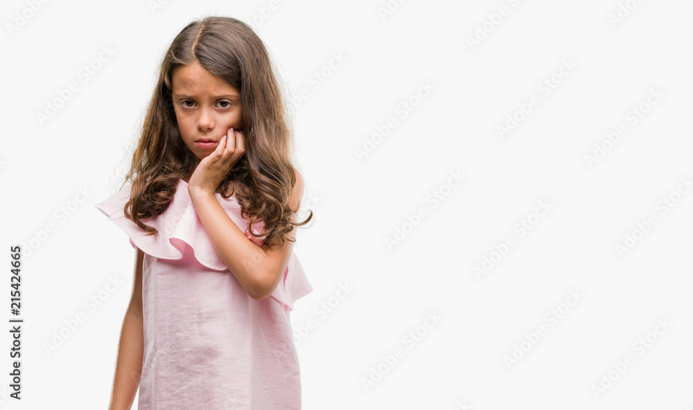 Brunette hispanic girl wearing pink dress touching mouth with hand with painful expression because of toothache or dental illness on teeth. Dentist concept. Brunette hispanic girl wearing pink dress touching mouth with hand with painful expression because of toothache or dental illness on teeth. Dentist concept.