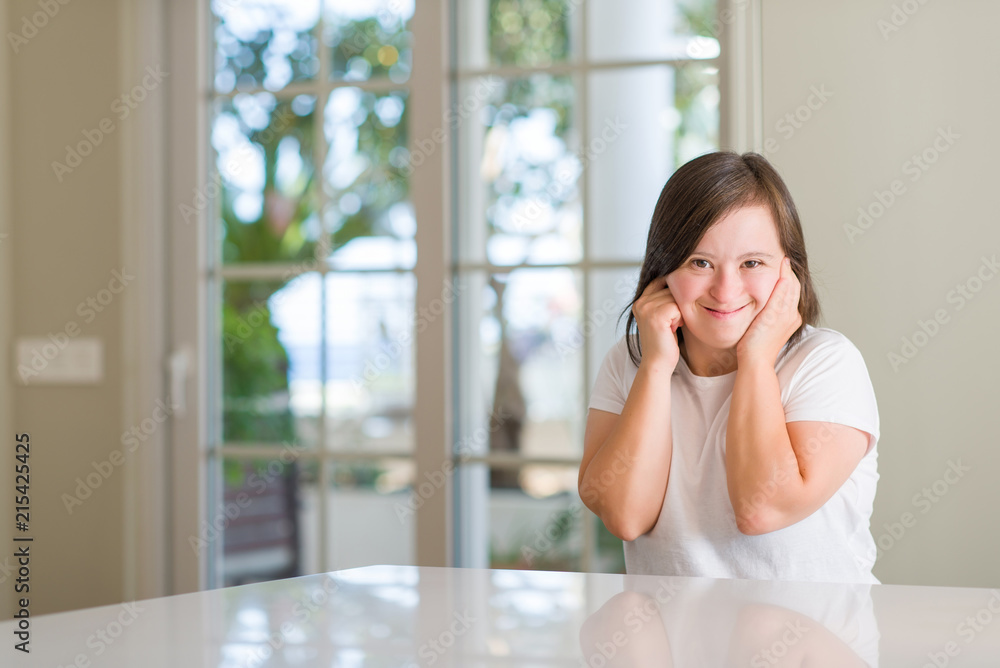 Down syndrome woman at home covering ears with fingers with annoyed expression for the noise of loud music. Deaf concept. Down syndrome woman at home covering ears with fingers with annoyed expression for the noise of loud music. Deaf concept.
