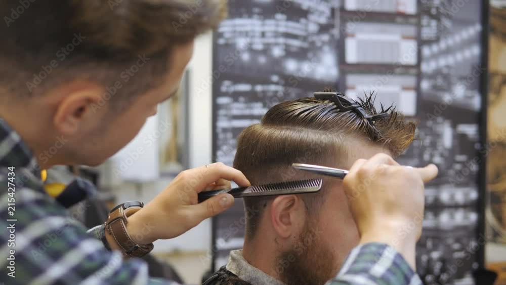 Hairdresser for men. Hairdresser with a haircut works for a