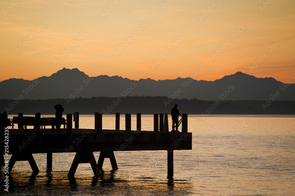 Sunset at Anchor Park in West Seattle, Washington. On a warm summer evening people flock to Alki Beach and Anchor Park for beautiful sunset views. 