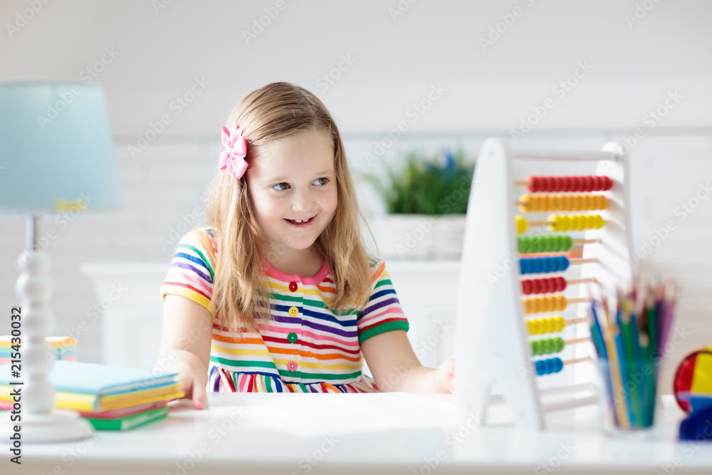 Child with abacus doing homework after school. Child with abacus doing homework after school.