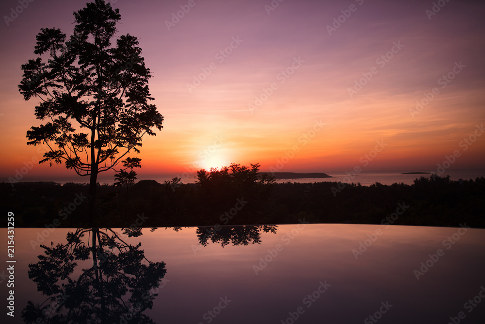 Infinity pool of tropical resort at sunset