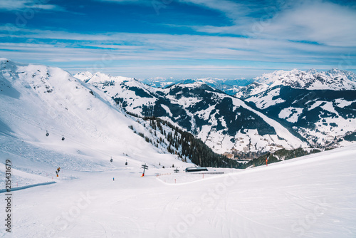 Ski lefts and cable cars in the Alps winter resort. People going up for skiing and snowboarding. Austrian Alps