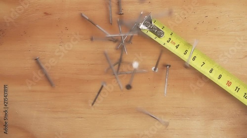 Super Slow Motion of Nails Falling and Bouncing onto a Wood Surface. photo