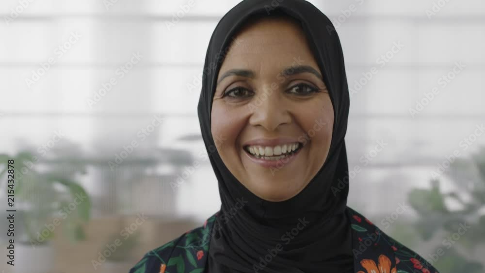 close up portrait of senior muslim business woman laughing cheerful looking at camera wearing traditional headscarf close up portrait of senior muslim business woman laughing cheerful looking at camera wearing traditional headscarf