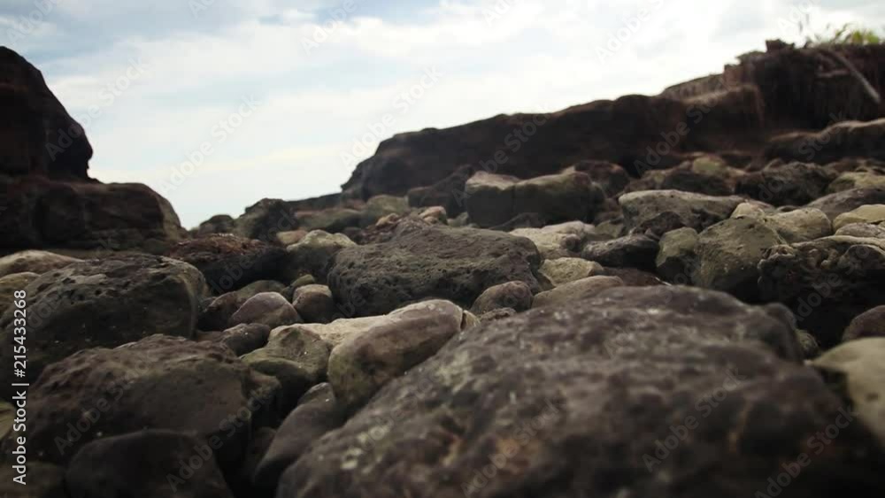 Walking over the rocks on the beach in slow motion. Walking over the rocks on the beach in slow motion.