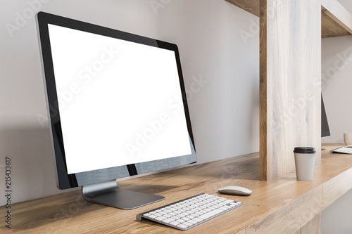 Mock up computer screen on wood table home office © ImageFlow