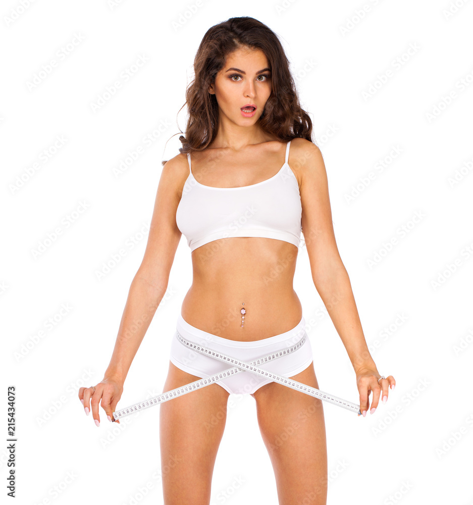 Fototapeta premium Young beautiful woman in white fitness clothing