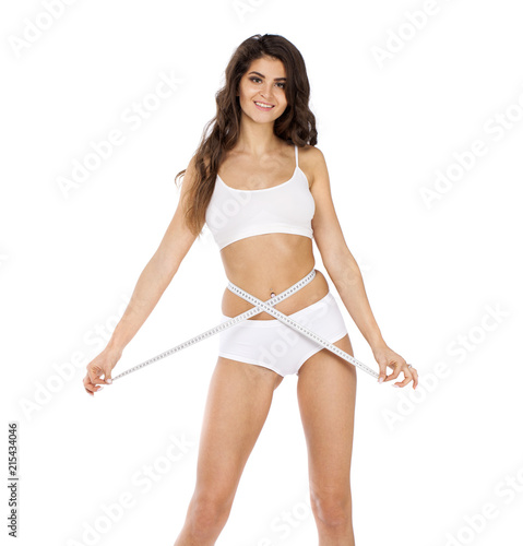 Young beautiful woman in white fitness clothing