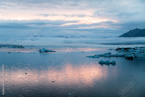 Dusk picture of Glacier Lagoon in Iceland with low altitude clouds and glacier moraine in the background