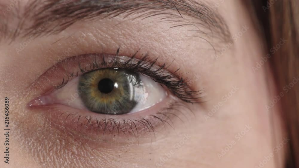 close up woman eye opening looking at camera iris beauty detail shot close up woman eye opening looking at camera iris beauty detail shot