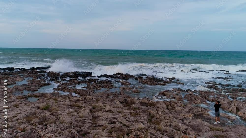 Aerial view of rocky coastline with crashing waves. Aerial view of rocky coastline with crashing waves.