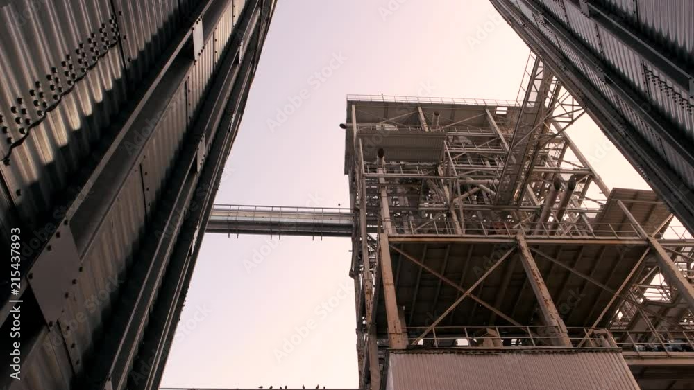 Huge metal building, up view. Look up, abstract steel construction. Huge metal building, up view. Look up, abstract steel construction.