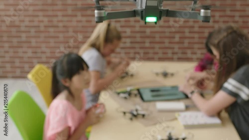 pov young group of multi ethnic student girls building drones together smart intelligent children design uav technology in vibrant classroom photo