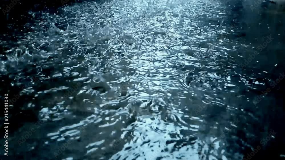 slow motion heavy rain water drops on surface street slow motion heavy rain water drops on surface street