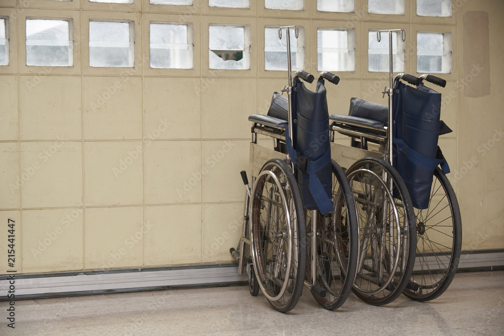 Two wheelchairs parking in an old building Two wheelchairs parking in an old building