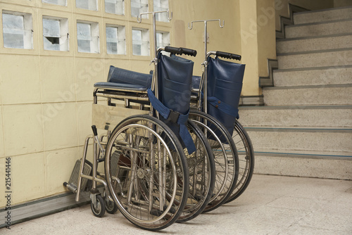 Two wheelchairs parking in an old building