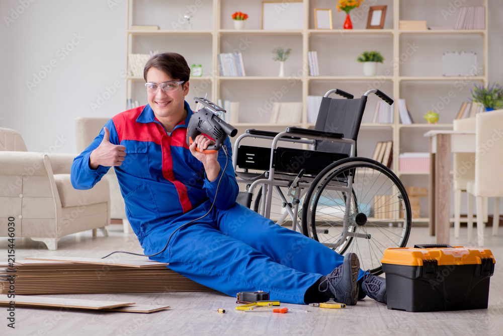 Disabled man laying floor laminate in office Disabled man laying floor laminate in office