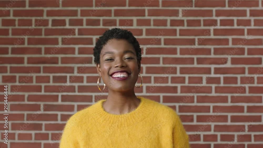 beautiful portrait of independent african american woman laughing cheerful excited wearing yellow jersey beautiful portrait of independent african american woman laughing cheerful excited wearing yellow jersey