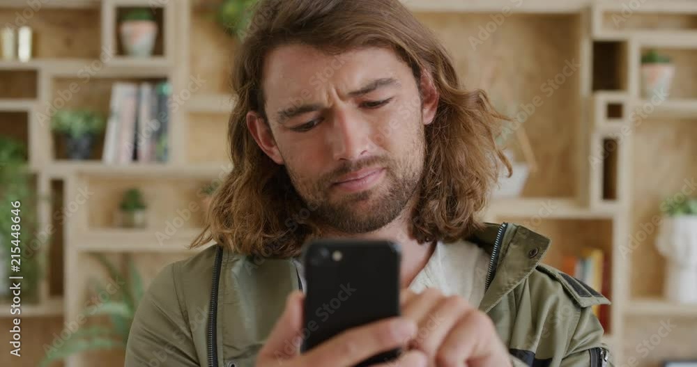close up portrait of young man student using smartphone texting browsing enjoying reading online social media messages smiling slow motion close up portrait of young man student using smartphone texting browsing enjoying reading online social media messages smiling slow motion