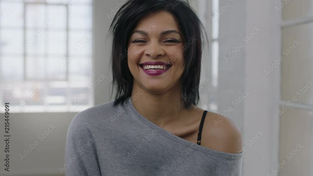 portrait of independent young mixed race woman laughing cheerful looking at camera enjoying fun portrait of independent young mixed race woman laughing cheerful looking at camera enjoying fun
