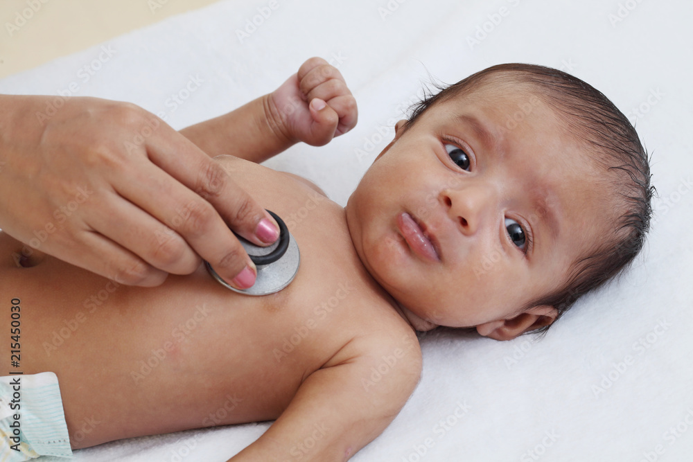 Doctor examine newborn baby with stethoscope Doctor examine newborn baby with stethoscope