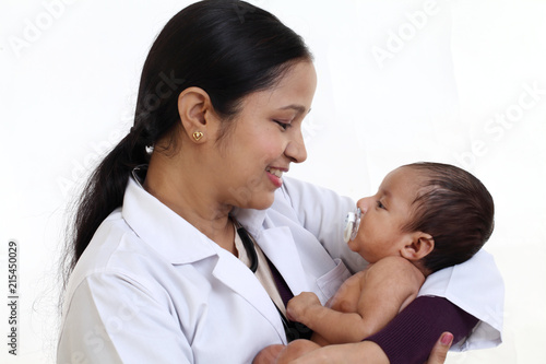 Photography Cheerful female pediatrician holds newborn baby