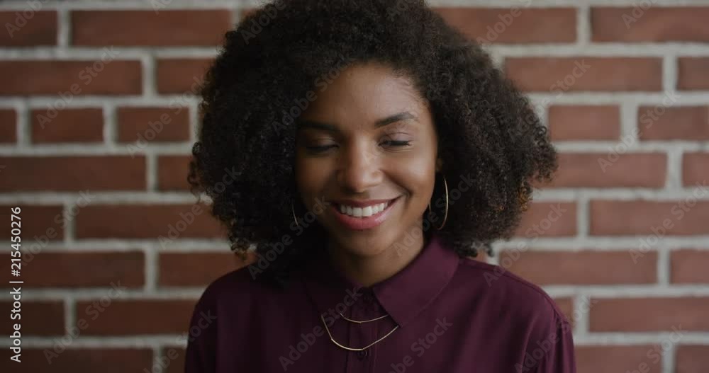 portrait stylish young african american woman smiling enjoying independent lifestyle happy trendy black female afro hairstyle brick wall background portrait stylish young african american woman smiling enjoying independent lifestyle happy trendy black female afro hairstyle brick wall background