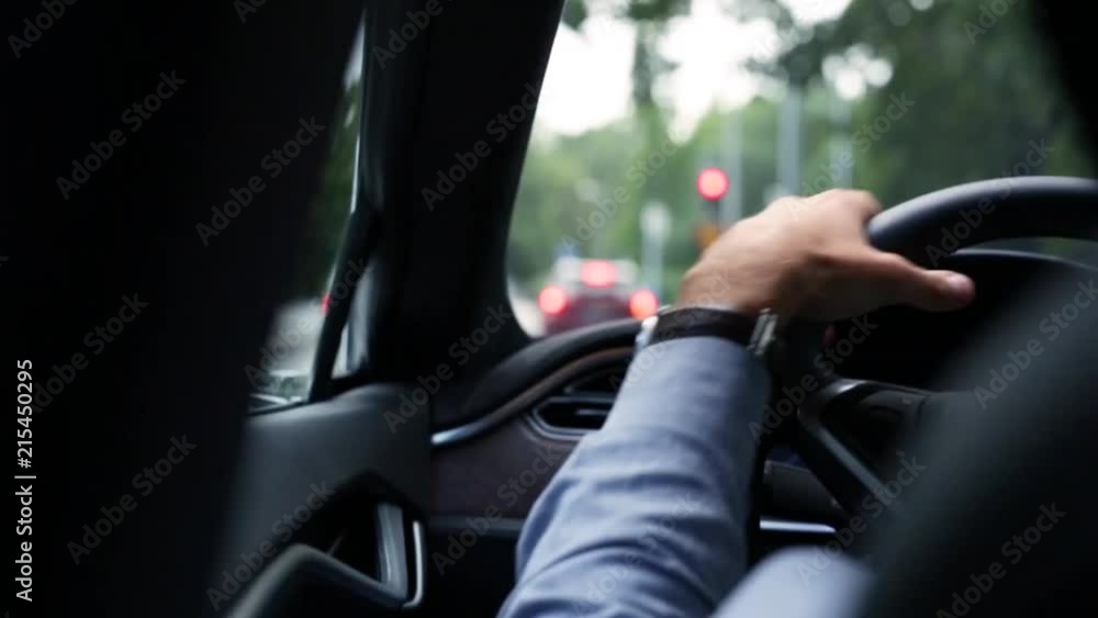 Smooth shot of a man driving wearing a blue shirt and a watch. Subtle slow motion makes this a fluid and an elegant shot. Smooth shot of a man driving wearing a blue shirt and a watch. Subtle slow motion makes this a fluid and an elegant shot.