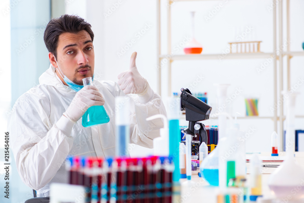Young chemist student working in lab on chemicals Young chemist student working in lab on chemicals