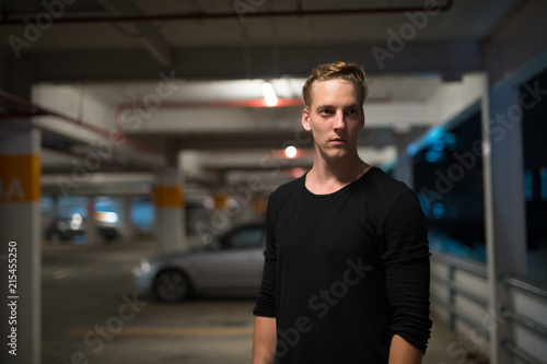 Bild auf Leinwand Young Handsome Man Outdoors At Night