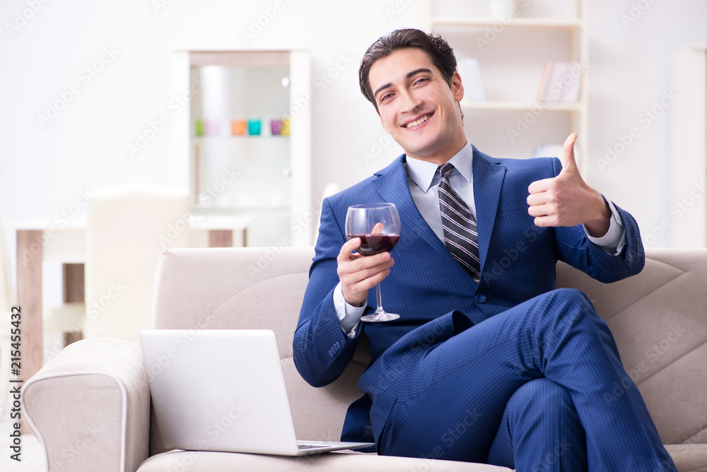 Businessman drinking wine sitting at home Businessman drinking wine sitting at home