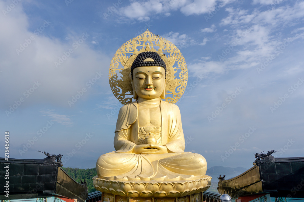 Big golden sitting Buddha image statue over the top of Bohyunsa Temple in Goseong, South Korea. Big golden sitting Buddha image statue over the top of Bohyunsa Temple in Goseong, South Korea.