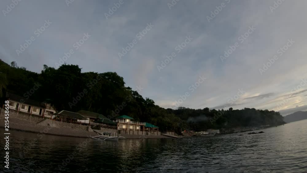 Boats docked on a tranquil lake at sunset Boats docked on a tranquil lake at sunset