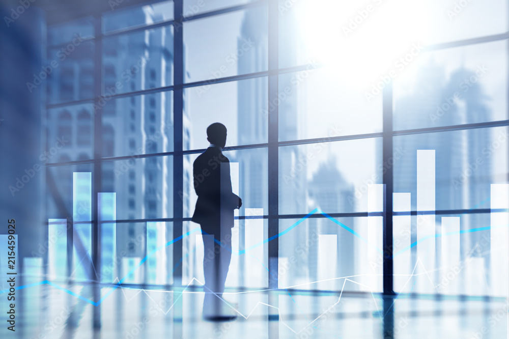 Financial graphs and charts on blurred business center background. Invesment and trading concept. Financial graphs and charts on blurred business center background. Invesment and trading concept.
