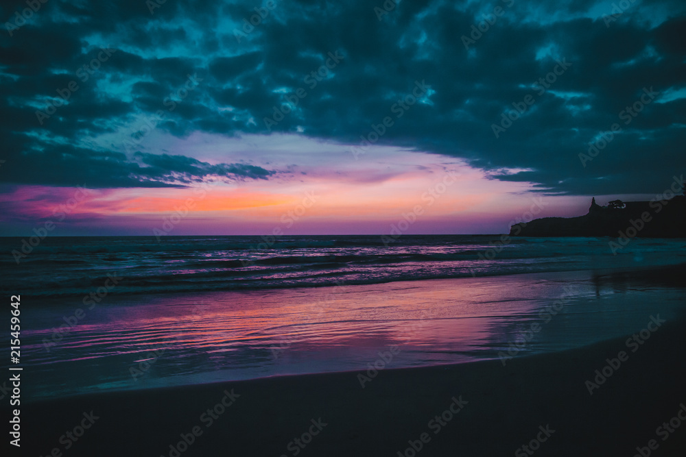 Purple sunset over the Pacific Ocean and beach of Montañita, Ecuador, a popular destination for surfers