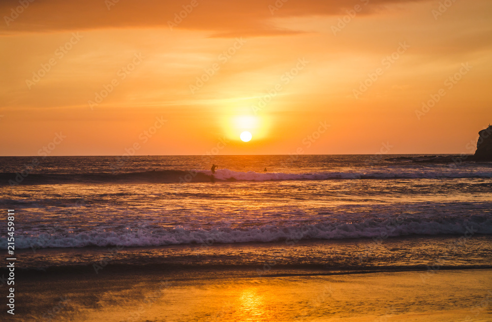Warm sunset over the Pacific Ocean and beach of Montañita, Ecuador, a popular destination for surfers