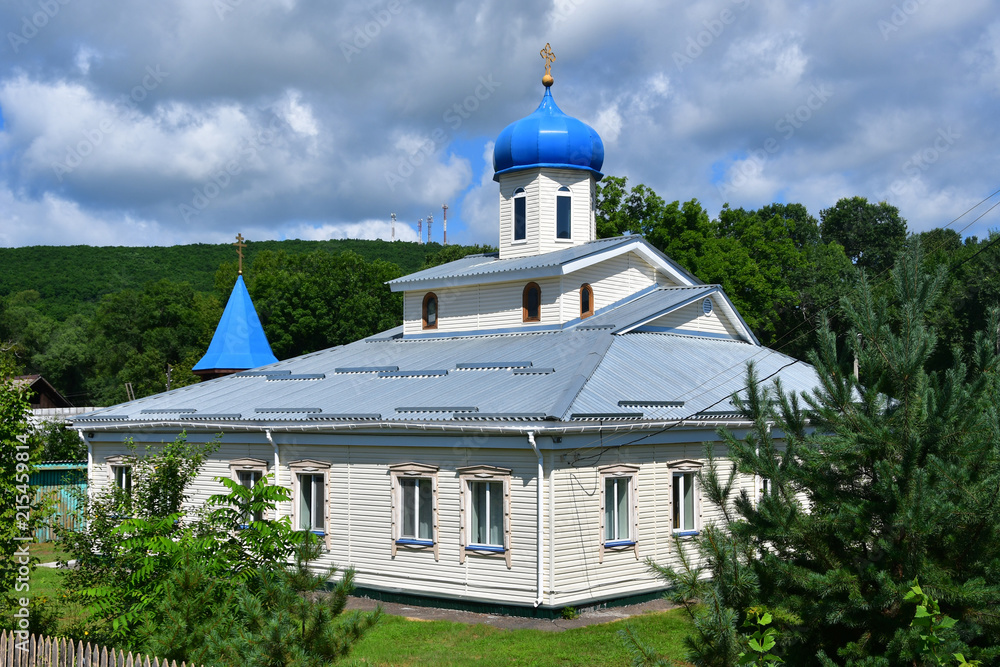 Wooden church of the Intercession of the Mother of God in the village of Anuchino in summer. Primorsky Krai, Russia