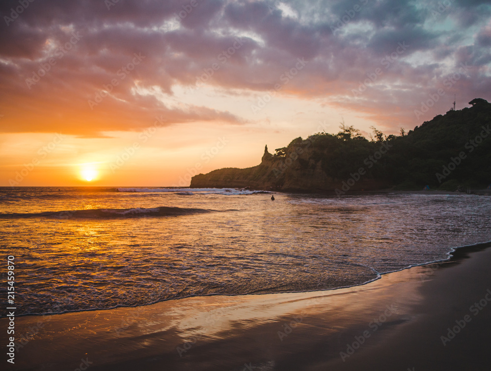Warm sunset over the Pacific Ocean and beach of Montañita, Ecuador, a popular destination for surfers