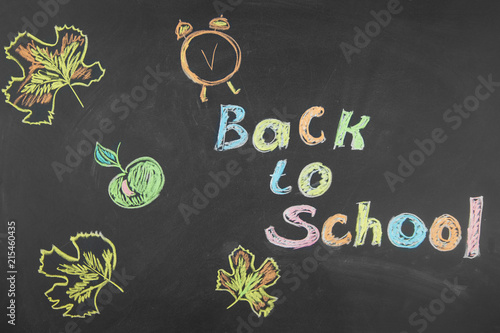 Back to school. School accessories chalked on the blackboard