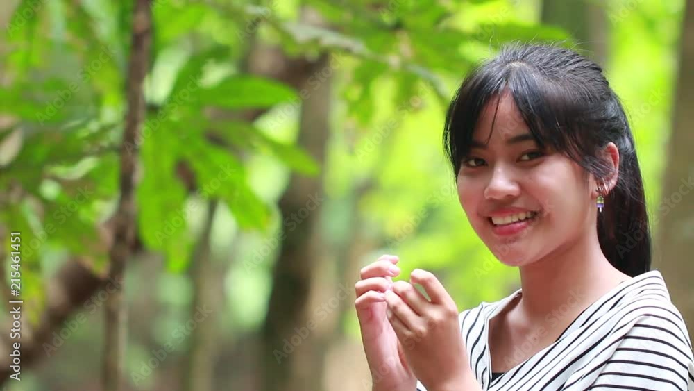 Young girls Asian students happy smiling looking at camera with blur of trees background in relax outdoor. Portrait of people, race and ethnicity concept Young girls Asian students happy smiling looking at camera with blur of trees background in relax outdoor. Portrait of people, race and ethnicity concept