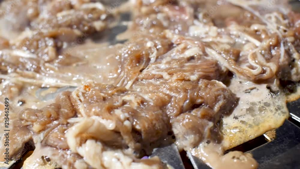 Closeup of Bulgogi cooking on Korean Style grill in slow motion Closeup of Bulgogi cooking on Korean Style grill in slow motion