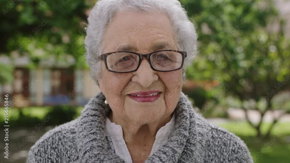 portrait of happy elderly woman in park laughing enjoying retired lifestyle portrait of happy elderly woman in park laughing enjoying retired lifestyle
