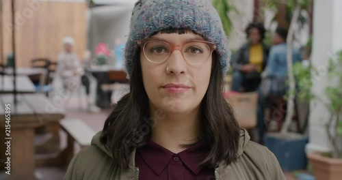 Wallpaper Mural portrait of young caucasian hipster woman looking at camera serious pensive wearing beanie hat in urban outdoors restaurant background Torontodigital.ca