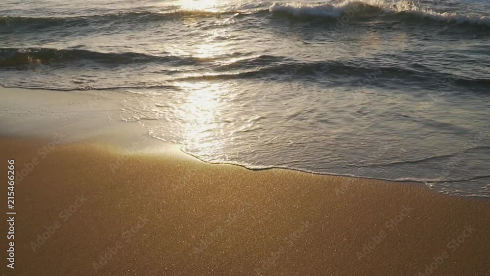 slow motion golden water lapping on shore sunrise slow motion golden water lapping on shore sunrise