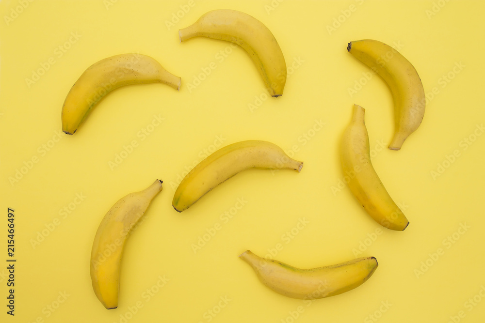 banana pattern on a yellow background. Exotic fruit repetition viewed from above. Top view. banana pattern on a yellow background. Exotic fruit repetition viewed from above. Top view.