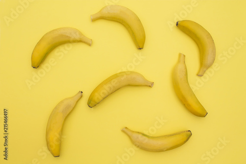 banana pattern on a yellow background. Exotic fruit repetition viewed from above. Top view.