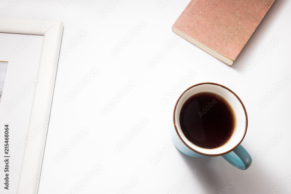 Picture frame with a cup of tea and notebook on white background Picture frame with a cup of tea and notebook on white background